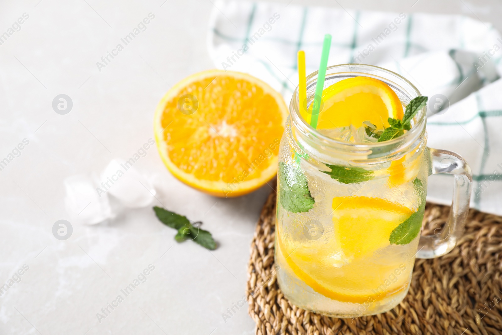 Photo of Delicious refreshing drink on light table. Space for text