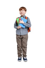 Little schoolboy with backpack and books on white background