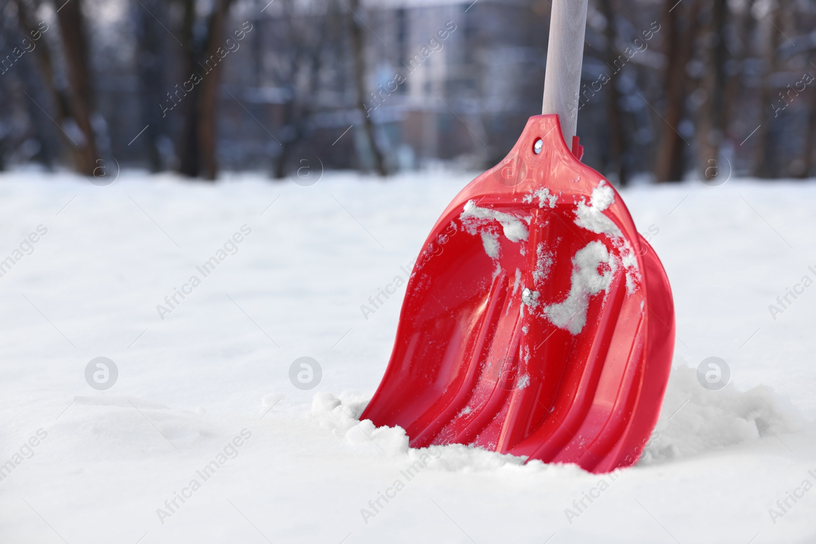 Photo of Snow shovel with wooden handle outdoors. Space for text