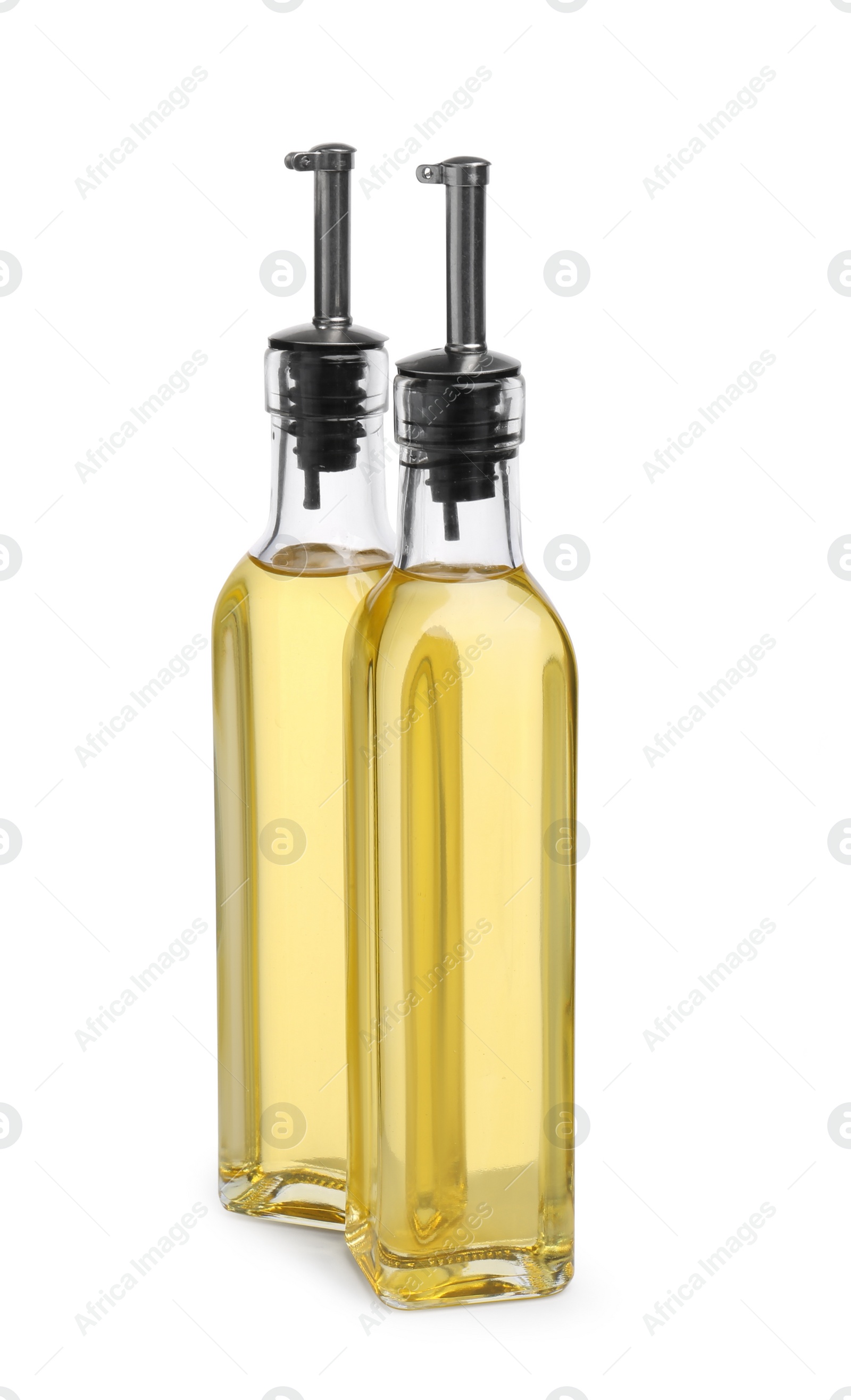 Photo of Glass bottles of cooking oil on white background