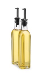 Glass bottles of cooking oil on white background