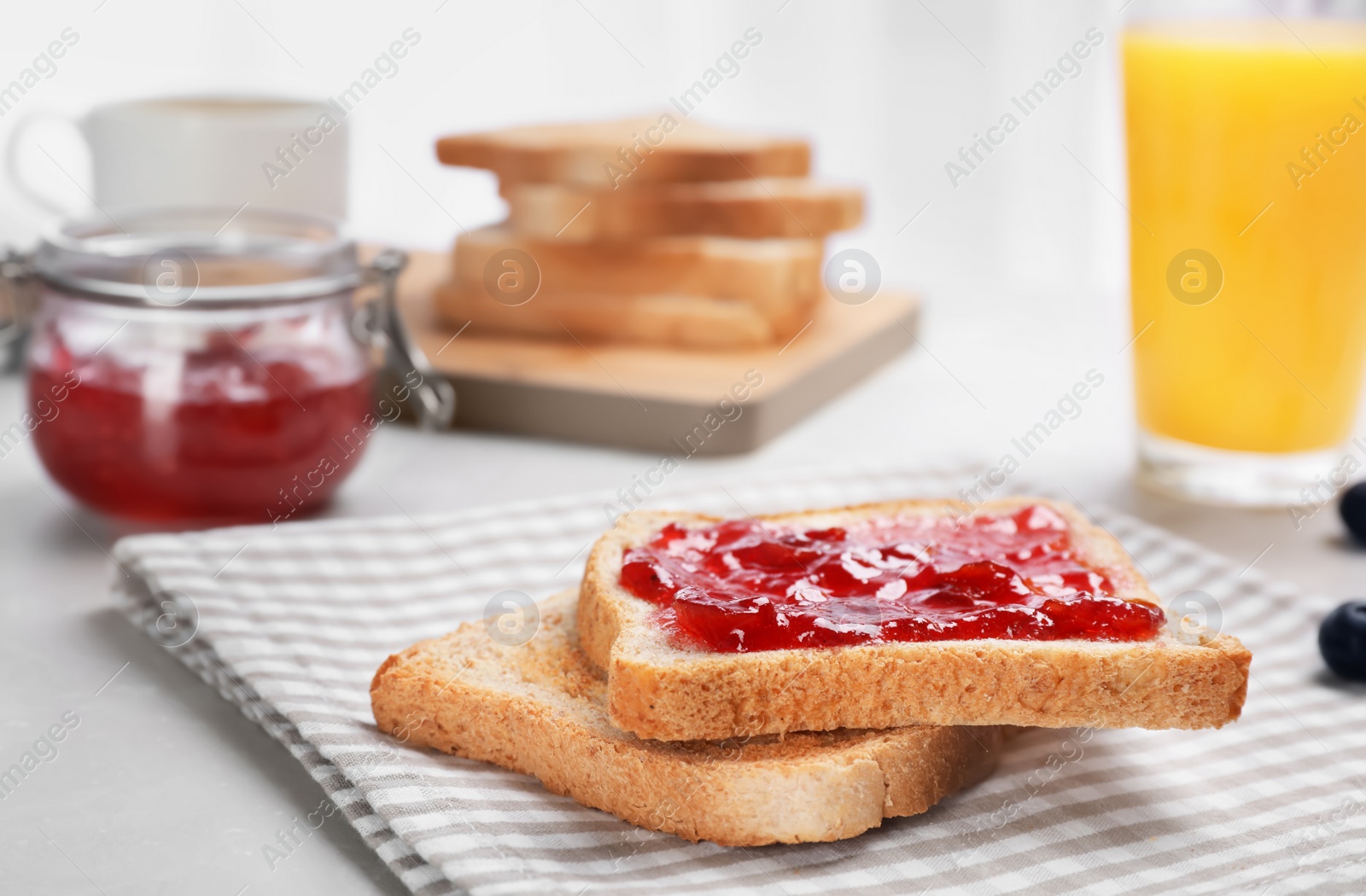 Photo of Toasts with jam on table, closeup