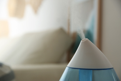 Modern humidifier indoors, closeup. Space for text