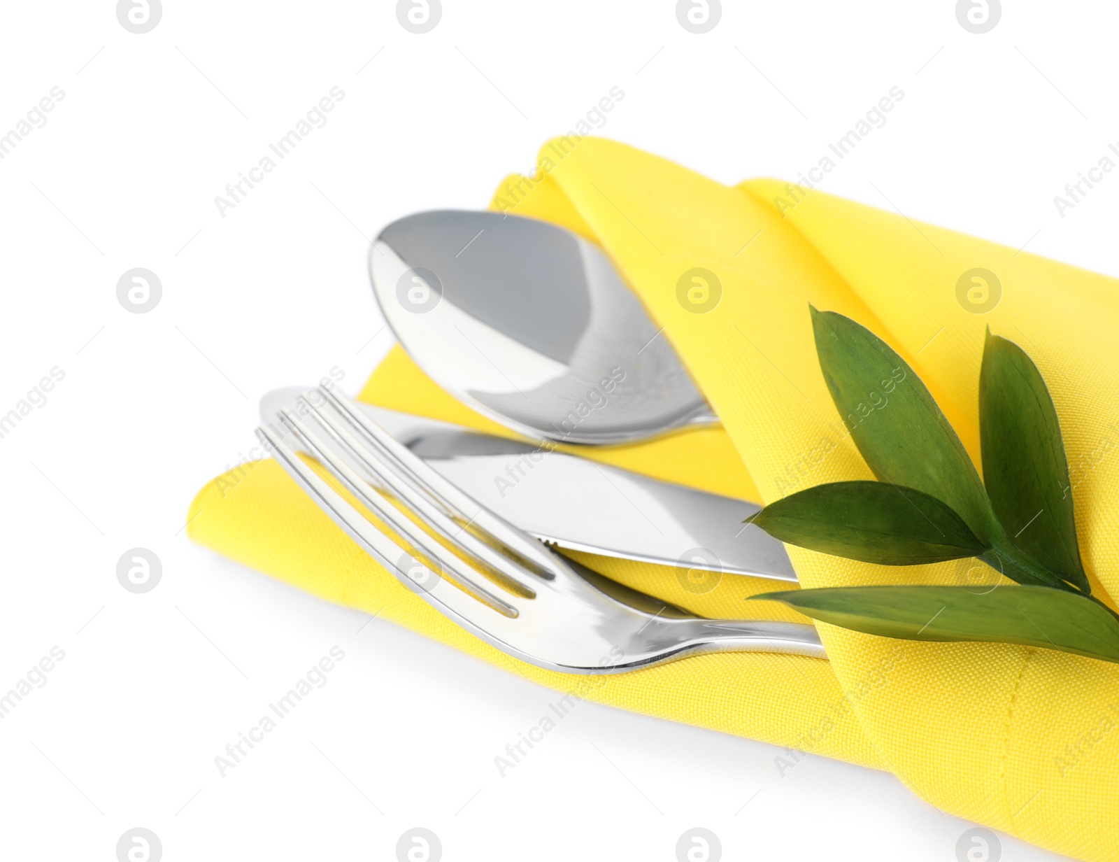 Photo of Folded napkin with fork, spoon and knife on white background, closeup