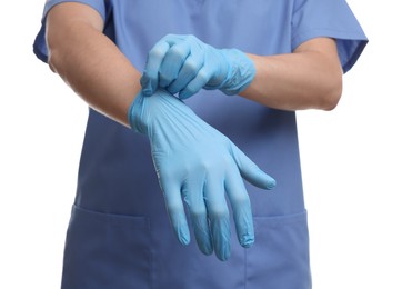 Doctor wearing light blue medical glove on white background, closeup