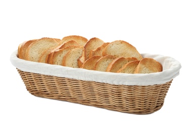 Slices of toasted bread in basket on white background