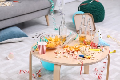 Wooden table with mess after party indoors