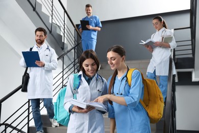 Photo of Medical students wearing uniforms on staircase in college