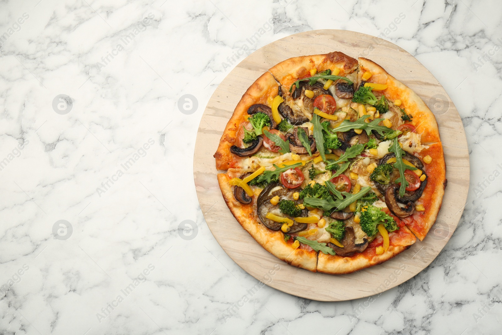 Photo of Delicious vegetarian pizza with mushrooms, vegetables and arugula on white marble table, top view. Space for text