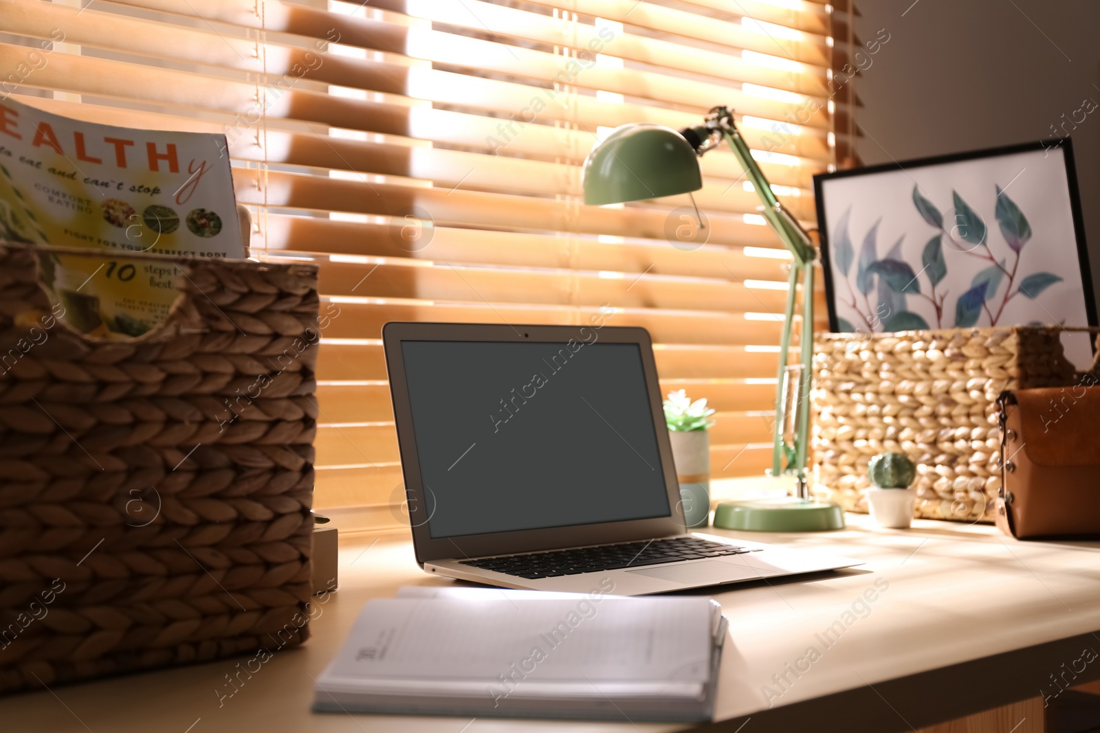 Photo of Comfortable workplace with laptop near window at home