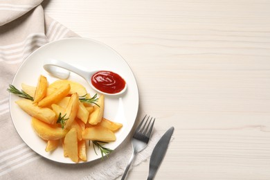 Plate with tasty baked potato wedges, rosemary and sauce on white wooden table, flat lay. Space for text