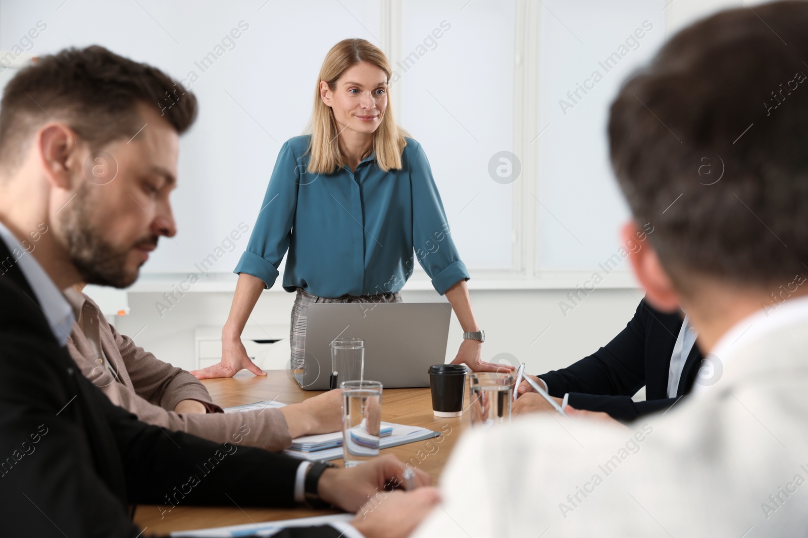 Photo of Businesswoman with her employees on meeting in office