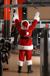 Photo of Authentic Santa Claus training in modern gym