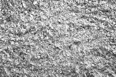 Photo of Crumpled silver foil as background, closeup view