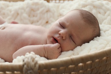 Photo of Adorable little baby sleeping in soft cradle, closeup