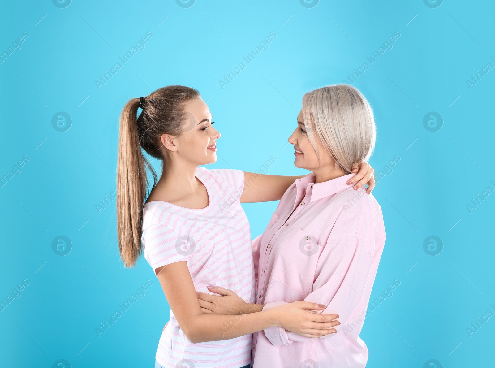 Photo of Portrait of young woman with her mature mother on color background