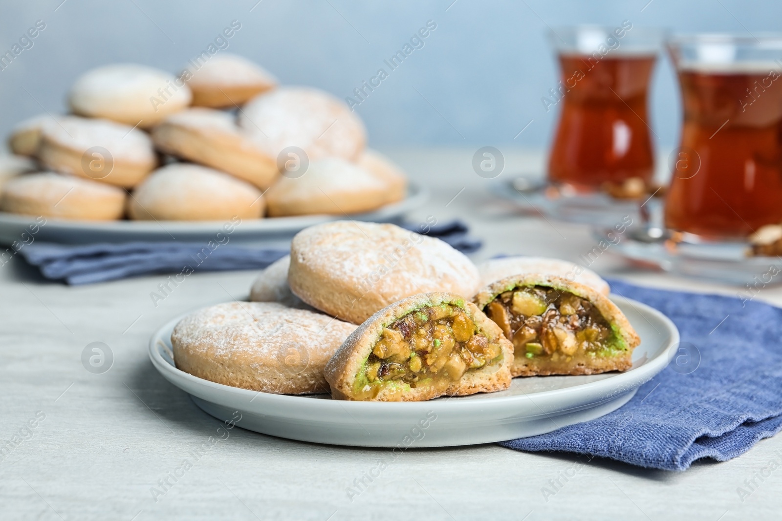 Photo of Plate of traditional cookies for Islamic holidays on table. Eid Mubarak