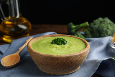 Delicious broccoli cream soup served on table