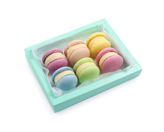 Photo of Many delicious colorful macarons in box on white background