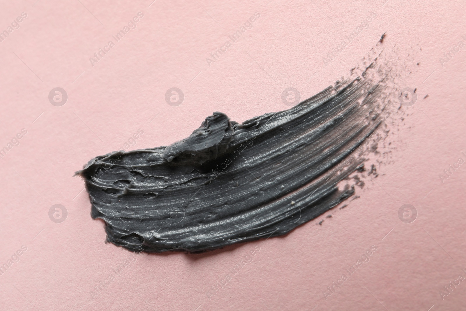 Photo of Sample of face mask on pink background, top view