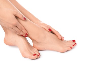 Photo of Woman with stylish red toenails after pedicure procedure isolated on white, closeup