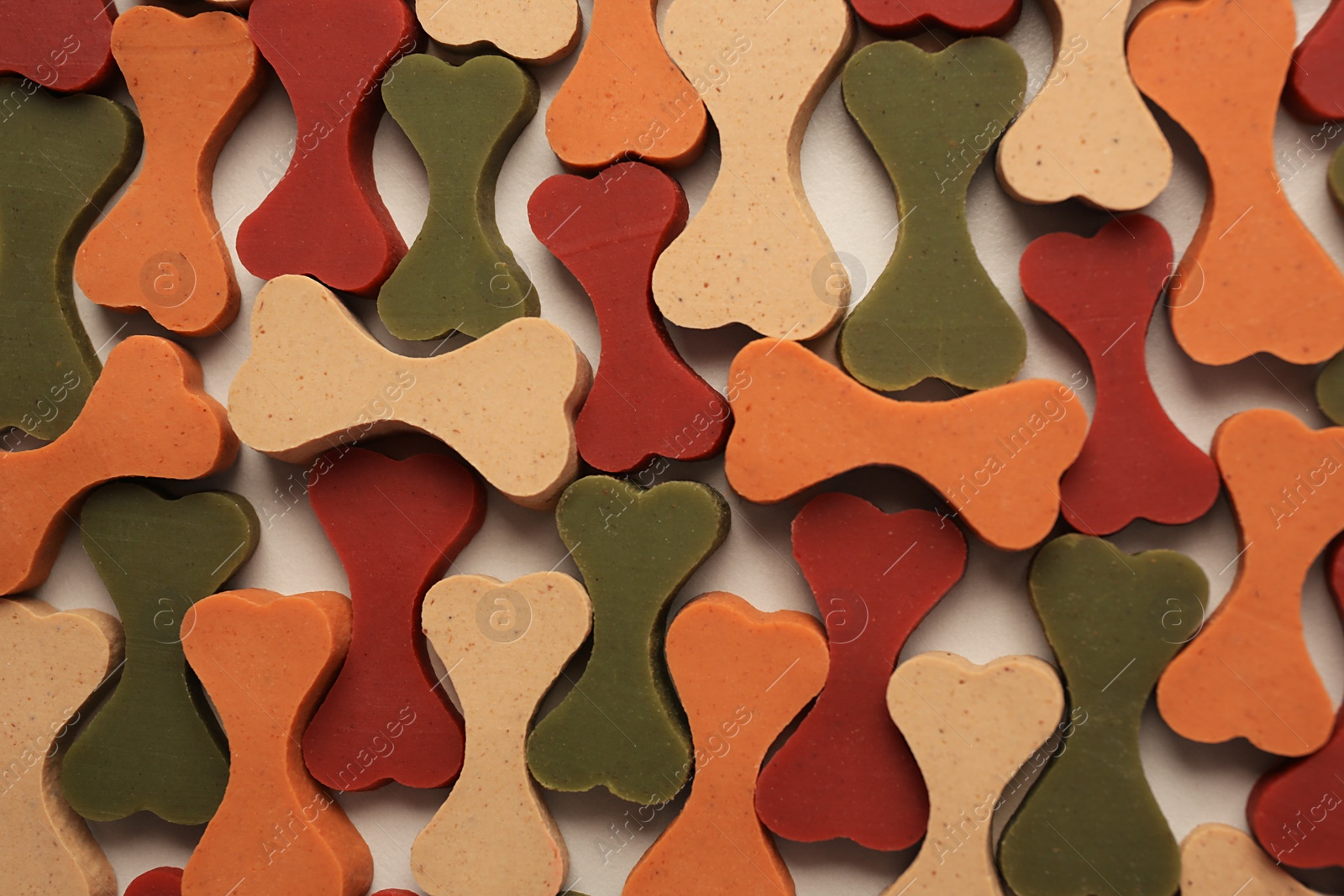 Photo of Flat lay composition with many bone shaped vitamins for pets on beige background