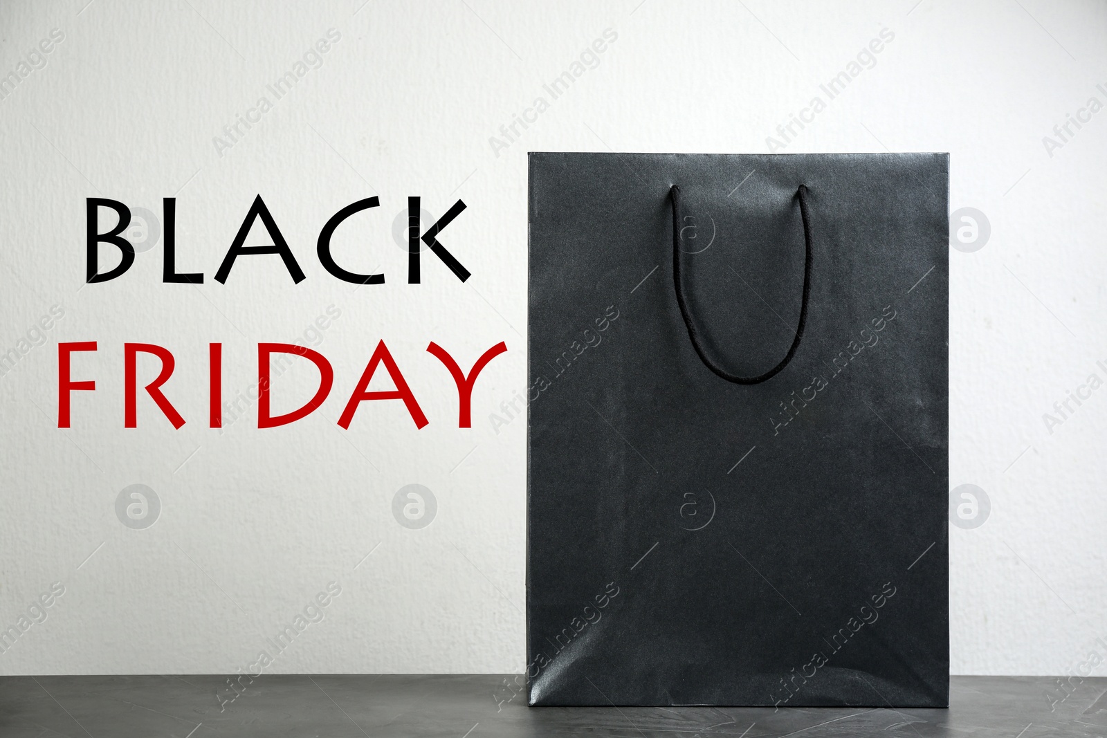 Image of Shopping bag and text BLACK FRIDAY on light background