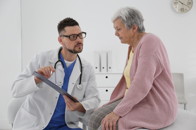 Doctor with senior patient in modern office