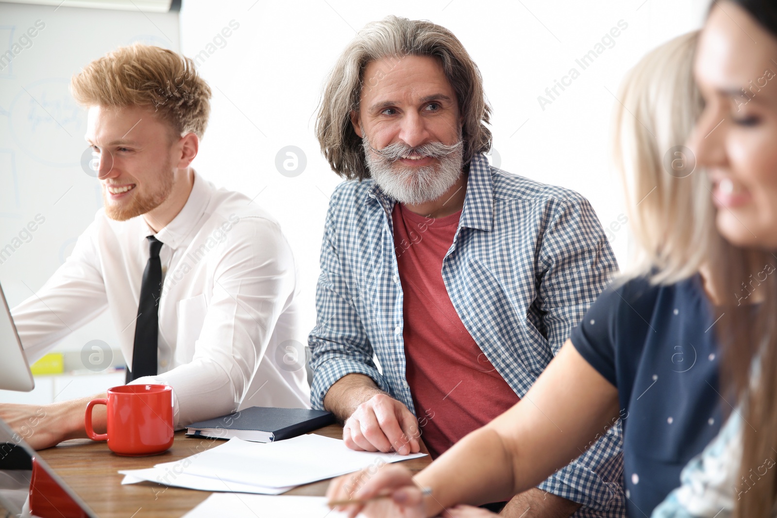 Photo of Business people discussing work matters in office. Professional communication