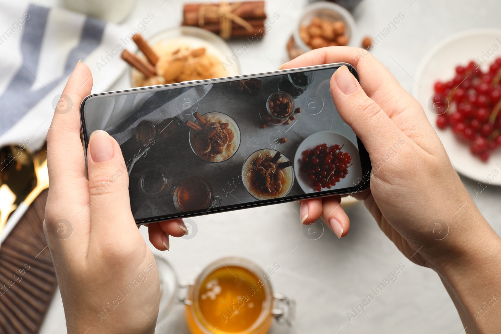 Photo of Blogger taking photo of delicious rice pudding at marble table, top view