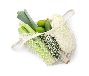 Photo of String bag with different vegetables isolated on white, top view