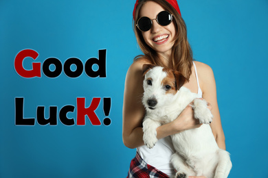 Image of Young woman with her dog and phrase GOOD LUCK on light blue background