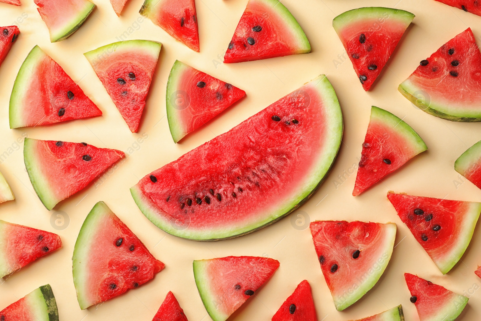 Photo of Flat lay composition with slices of watermelon on color background