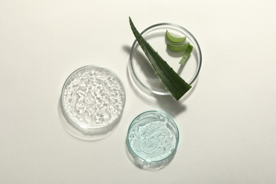 Photo of Flat lay composition with cosmetic gel and aloe on white background