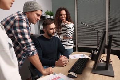 Photo of Team of employees working together in office. Startup project