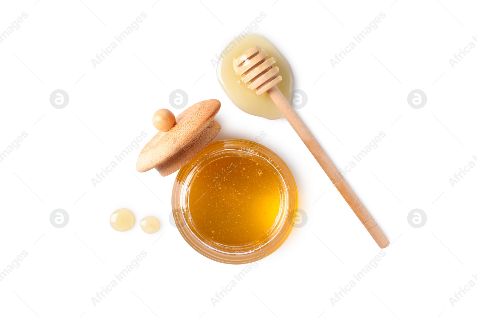 Photo of Tasty honey in glass jar and dipper on white background, top view