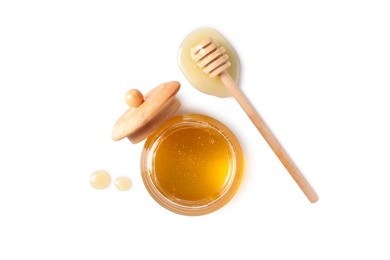 Photo of Tasty honey in glass jar and dipper on white background, top view