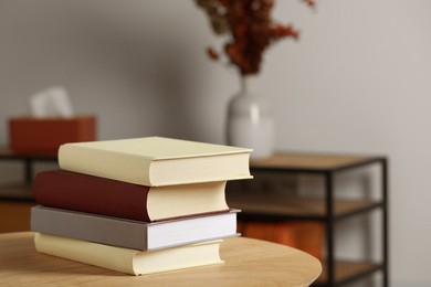 Photo of Many books stacked on wooden table indoors, space for text
