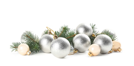Beautiful Christmas balls and fir branches on white background
