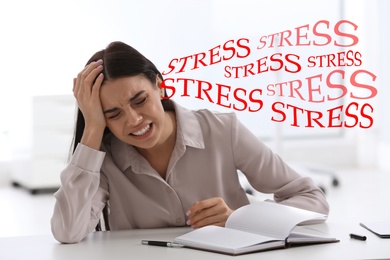 Image of Stressed young woman at table in office