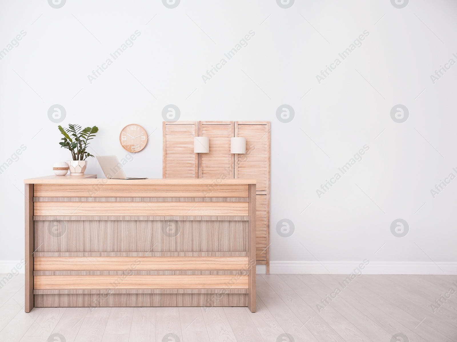 Photo of Hotel lobby interior with wooden reception desk