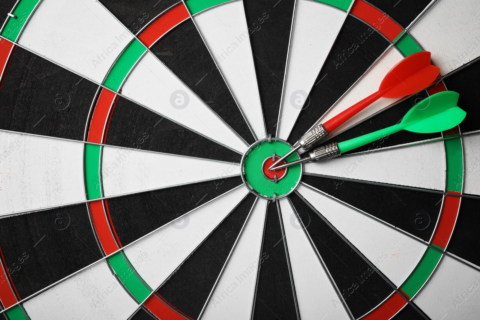 Photo of Red and green arrows on dart board, top view