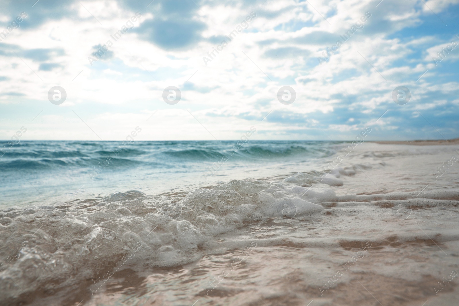 Photo of Sea waves rolling onto sandy tropical beach