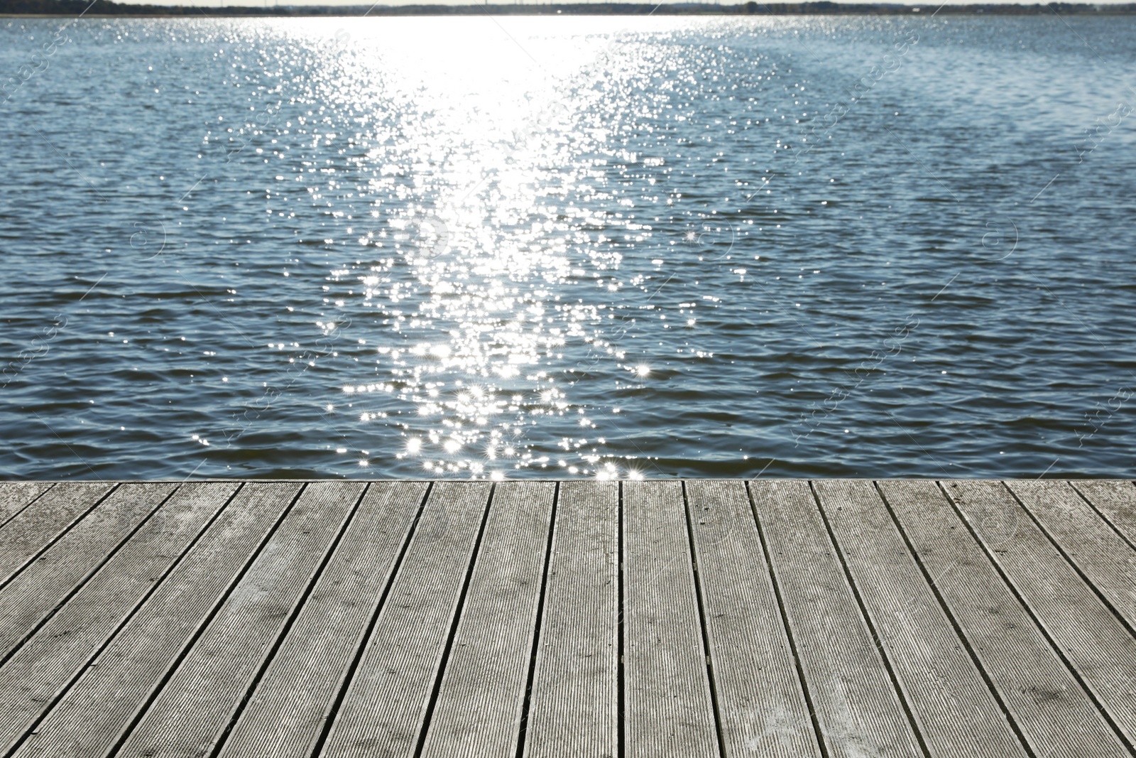 Photo of Beautiful view of wooden terrace near river on sunny day