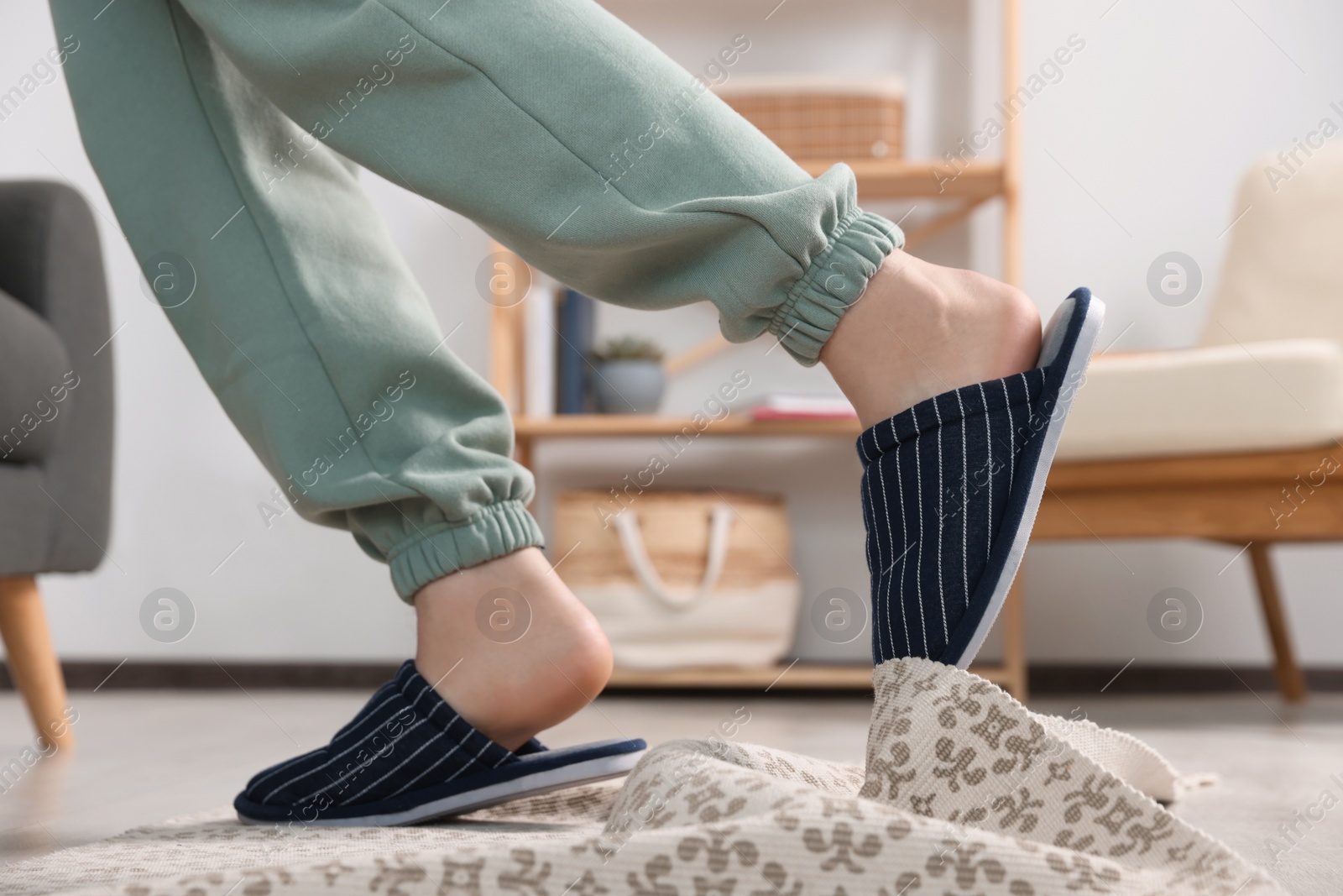 Photo of Man tripping over rug at home, closeup