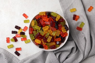 Delicious gummy bear candies on light table, flat lay