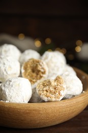Tasty snowball cookies in wooden bowl, closeup. Christmas treat