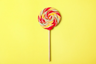 Tasty colorful fruit flavored candy on color background, top view