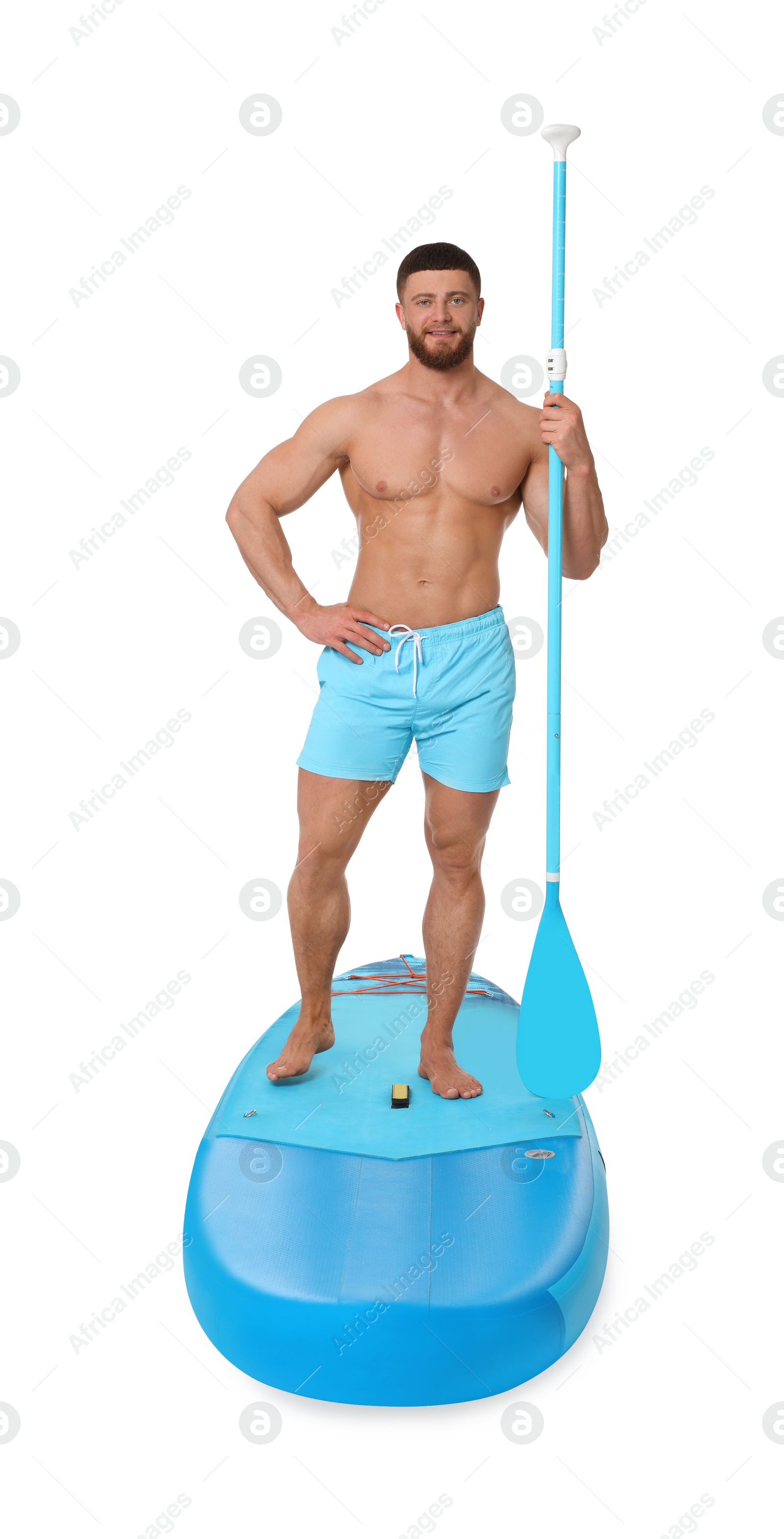 Photo of Handsome man with paddle on blue SUP board against white background