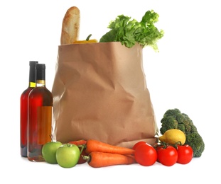 Photo of Paper bag full of products on white background